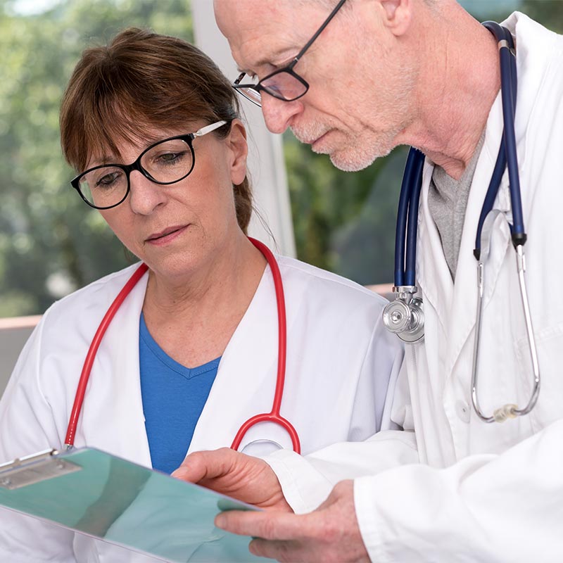 Two doctors examining paperwork